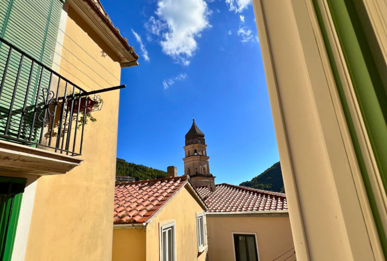 view from the window to blue sky and terracotta roof