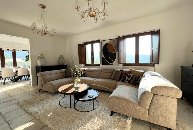 Lounge sofa in front of window with brown shutters open