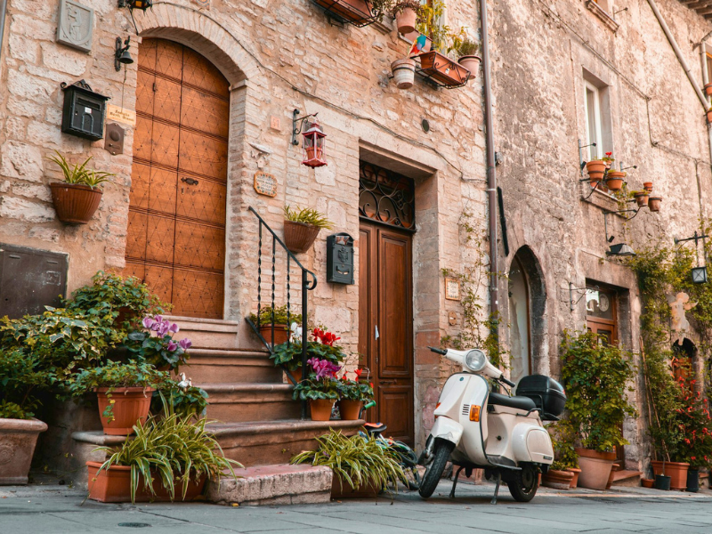 Italian street with steps up to a wooden door and house