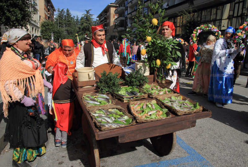 People with carnival costumes dance and parade through the streets of Avellino in Campania