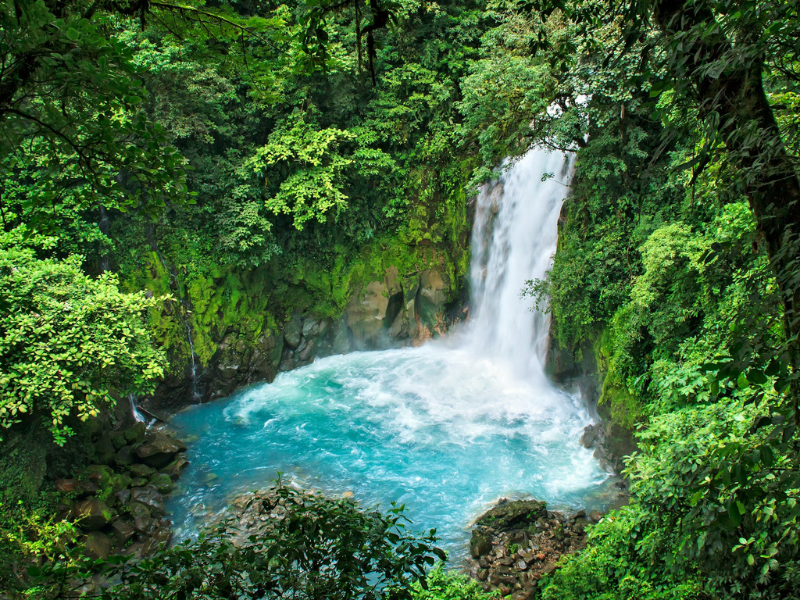 costa rica area guide waterfall into blue pool at bottom