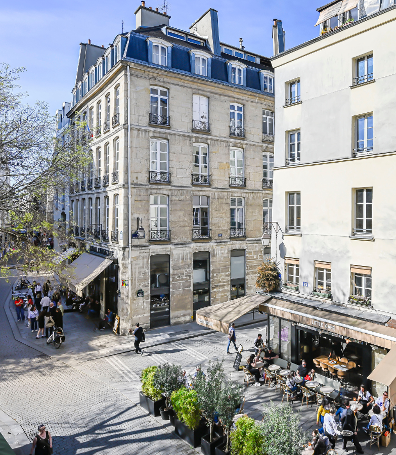 Paris building exterior with cafes below